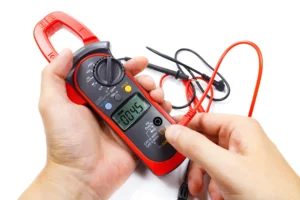 Using a versatile clamp meter to check current.